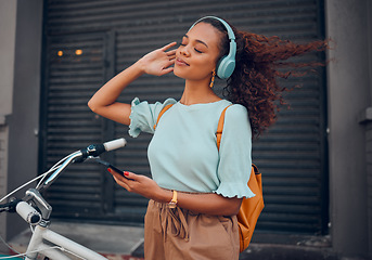 Image showing Bicycle, phone and black woman on headphones in city streaming audio, music or podcast. Happy, travel and female from South Africa with bike, 5g mobile and listening to radio sound track on headset.