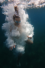 Image showing Underwater swimmer surrounded by bubbles