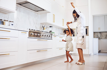 Image showing Dance, playful child and mother being comic, crazy and free with a girl in the kitchen together at home. Care, love and happy kid dancing with her mom in freedom while listening to music in house