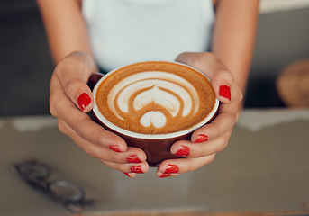 Image showing Cafe, art and coffee woman hands holding caffeine drink cup for leisure break with top view. Barista, espresso and design of cappuccino beverage of girl customer at restaurant table close up.