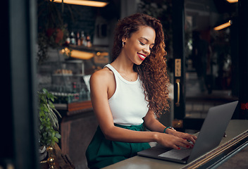 Image showing Laptop, internet cafe and typing with a black woman blogger working at the window of a coffee shop on an article or report. Computer, email and remote work with a female writer busy in a restaurant