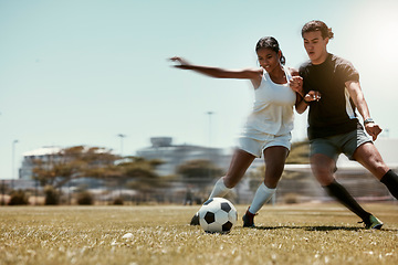 Image showing Sport, friends and soccer with man and woman playing on a soccer field, competitive training for sports goal. Fitness, couple and energy with interracial guy and lady having fun with outdoor football