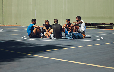 Image showing Teamwork, basketball and planning with friends relax on sports court for training, workout and fitness together. Exercise, goals and health with athlete men relax after game competition in outdoor