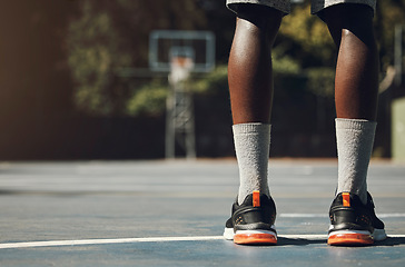 Image showing Basketball, sneakers and athlete black man standing on community sports court for match, motivation and streetball memory. Male player outside in USA with sport shoes on feet for fitness and exercise