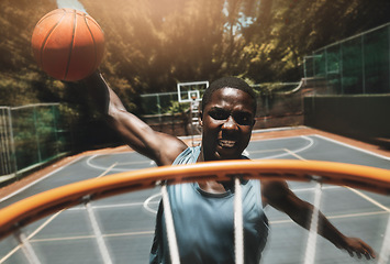 Image showing Basketball, sports goal and man training at basketball court with ball, jump and dunk skill practice. Energy, fitness and power by athletic black man focused on winning target during exercise workout