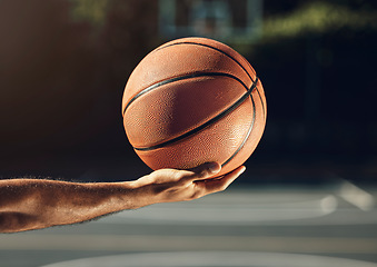 Image showing Sport, hand and basketball training at basketball court with man holding ball before practice. Fitness, health and sports guy getting ready for cardio, endurance and energy exercise alone outdoors