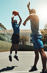 Image showing Basketball, sports game and man shooting for goal, fitness exercise and training workout on outdoor basketball court. Street competition, winner mindset and healthy athlete jump and playing match