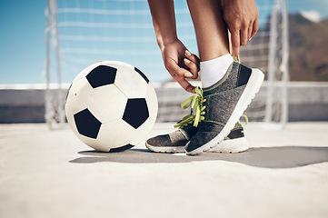 Image showing Fitness, football and feet with sport shoes standing with ball for a soccer game in summer ready to score goal. Exercise, training and practice with woman doing city workout with sneakers for fun