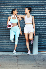 Image showing Fitness women, friends and yoga mat practice looking fit, slim and happy about exercise, training and workout standing against an urban background. Females together for aerobics, health and wellness