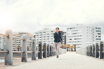 Image showing Sports, fitness and woman running on sidewalk with speed, energy and determination outdoors for exercise in Los Angeles. Girl, wellness and healthy runner sprinting for cardio training and workout