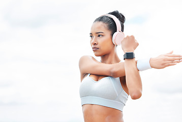 Image showing Arms, stretching or music headphones for fitness woman motivation in Indonesian workout, sweat training or exercise. Sports, personal trainer or runner listening to health podcast and wellness radio