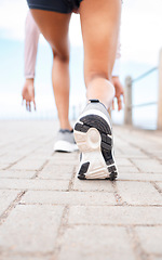 Image showing Runner feet, start and woman on path about to run fast for fitness, training and workout. Exercise, health and wellness, close up sports shoes of girl ready for running race or marathon with speed