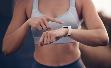 Image showing Fitness, time and woman runner with a smartwatch tracking running performance, heart rate and monitor training data. Sports, pointing and female athlete checking exercise or cardio workout progress