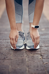 Image showing Fitness, stretching and woman with shoes and toes touch with smartwatch for workout, health and sports training. Exercise, wellness and performance with hands of athlete for outdoor cardio lifestyle