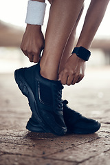 Image showing Running shoes, exercise and fitness woman with black sport shoe for training, workout and cardio outside. Closeup feet of female athlete or runner ready for run, walk or jog with sneakers or footwear