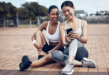 Image showing Friends, fitness app and phone of happy women on internet for social media, motivation message or exercise goal. Female runner or athlete with smartphone on training break and cardio workout outside