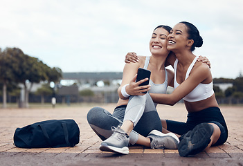 Image showing Workout, happy and friends with phone on floor after fitness training in the city of New York together. Runner and black woman talking about funny 5g mobile app after health exercise outdoor