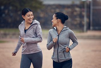 Image showing Women, friends and running in city, street or outdoors for fitness, health and wellness. Exercise, diversity and happy girls out for a run, workout or training and talking, speaking or chat together.