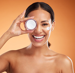 Image showing Beauty, skincare and cream product by black woman in studio, happy, smile and relax during face hygiene, grooming and routine. Wellness, skin and dermatology with portrait of lady excited for facial