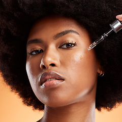 Image showing Oil, skincare and black woman with product for face against an orange studio background. Portrait of a young, African and cosmetic model with liquid serum for facial health, skin beauty and wellness