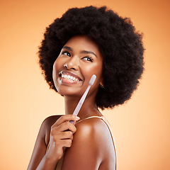 Image showing Toothbrush, dental and black woman with smile for teeth against a mockup orange studio background. Young, African and thinking model with wellness and health results from cleaning mouth with product