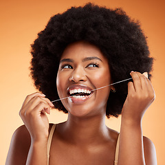 Image showing Flossing, dental and black woman cleaning teeth against an orange studio background. Young, African and thinking model with idea while getting results from care and wellness of mouth and tooth health