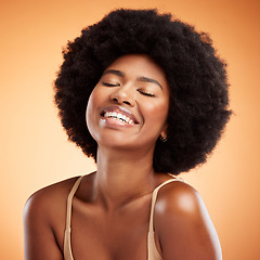 Image showing Black woman face, natural beauty and skincare health wellness on orange studio wall background. A happy african model smile, black female empowerment and healthy cosmetic luxury fashion afro haircare