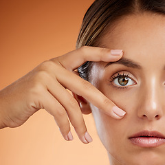 Image showing Vision, eye and beauty with face of woman for health awareness, awake and idea in orange background. Youth, cosmetics and inspiration with girl and zoom in stare for intense, serious or humanity