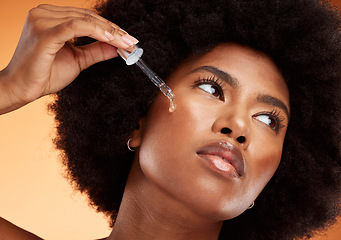 Image showing Face serum, skincare and black woman using beauty oil product with pipette for skin. Wellness, afro and natural female model from Nigeria with a dermatology dropper for moisturizing facial treatment