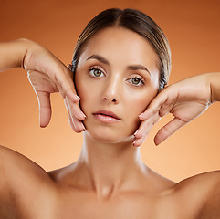 Image showing Skincare, beauty and woman with glow on face against an orange studio background. Portrait of a young, healthy and cosmetic model with body makeup, luxury dermatology and facial wellness and care