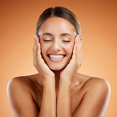 Image showing Skincare, beauty and woman excited about face makeup against mockup orange studio background. Happy, smile and young girl model with facial cosmetics and wellness from dermatology with mock up space