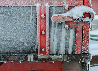 Image showing Frozen red colored handle on tractor trailer with ice crystals