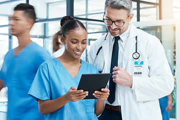 Image showing Diversity, doctor and nurse on a tablet planning a surgery strategy or talking about medical results in a hospital. Teamwork, collaboration and happy healthcare workers speaking and reading a report