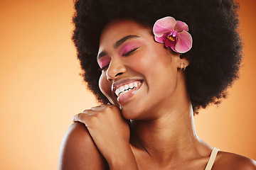 Image showing Beauty, smile and cosmetic makeup skincare of a black woman with an orchid looking happy. Natural hair, calm and cosmetics of a person from Jamaica feeling beautiful, relax and happiness in her skin