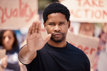 Image showing Protest, hand and stop with a black man in a demonstration or rally for human rights and equality. Justice, freedom and politics with a male activist ready to fight racism, violence or discrimination