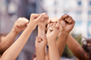 Image showing Diversity, hands and fist in community protest for human rights, racism and equality in fight for justice in the city. Group hand of people in strike for economic or government change in a urban town