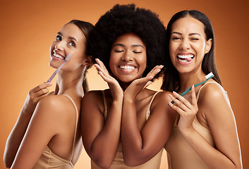 Image showing Beauty, smile and dental with women and toothbrush for teeth, oral healthcare and hygiene. Orthodontics, lifestyle and diversity with girls against orange background for wellness, clean or dentistry