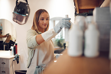 Image showing Salon, professional hairdresser and hair care shampoo treatment on product display in boutique. Small business owner, cosmetic wellness woman working and beauty products shelf arrangement in store