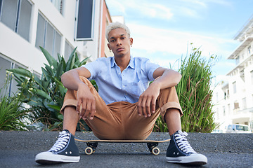 Image showing Skateboard, gen z and cool skater man in the city with a serious look outdoor. Portrait of a urban person from Mexico relax after skate training, fitness and cardio workout practice on the road