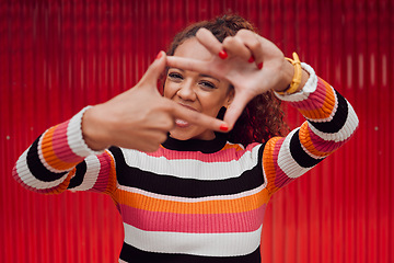 Image showing Happy, black woman and finger frame over eyes for funny face expression on red background. Fashion, comic and positive perspective with female from South Africa with hand gesture feeling playful