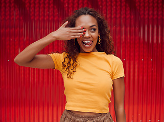 Image showing Happy, black woman and tongue out, cover eye or funny face on red background. Fashion, comic and goofy, crazy or silly facial expression of female from South Africa with hand on eyes feeling playful.