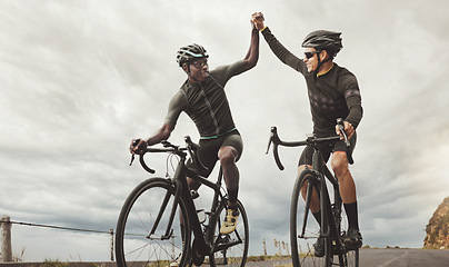 Image showing Cycling, friends and high five by men training, cycling and exercising in road with motivation, goal and energy. Fitness, success and hands in support of cycle team bonding in nature and celebrating