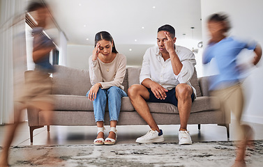 Image showing Headache, kids running and parents on a sofa in a living room, suffering stress, anxiety and adhd children. Family, autism and burnout crisis with woman and man in mental health and energy problem