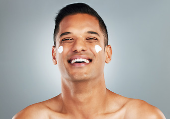 Image showing Happy man, face cream skincare and portrait moisturizer, healthy aesthetic and glowing skin on grey studio background. Smile headshot, male model or facial dermatology product, cosmetics and wellness