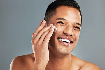 Image showing Happy man, face cream skincare and portrait moisturizer, healthy aesthetic and glowing skin on grey studio background. Smile headshot guy facial product, dermatology cosmetics or clean body wellness