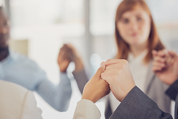 Image showing Hands, support and trust with a business team in solidarity during a prayer meeting in their office. Collaboration, community and faith with a diversity group hand in hand in the boardroom at work