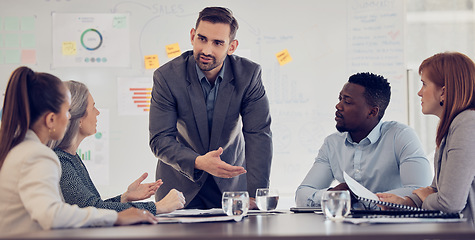 Image showing Businessman, speaker or presentation meeting with paper chart, infographic documents and survey research. Talking mentor, manager or leader in corporate training, diversity teamwork and collaboration