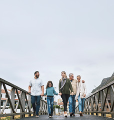 Image showing Happy, nature and big family on an outdoor walk adventure while on a vacation in Canada together. Grandparents, parents and girl child with a smile walking on a spring journey or holiday at a resort.