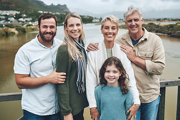 Image showing Travel, portrait and happy family on holiday vacation outdoors to enjoy quality time together in Ireland. Grandparents, mother and father on a bridge with child bonding and relaxing on a weekend trip