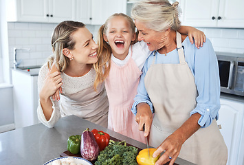 Image showing Mother, grandma and child cooking as as happy family in a house kitchen with organic vegetables for dinner. Grandmother, mom and young girl laughing, bonding and helping with healthy vegan food diet